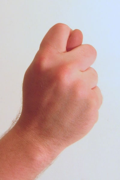 Gesture_fist_with_thumb_through_fingers-min
